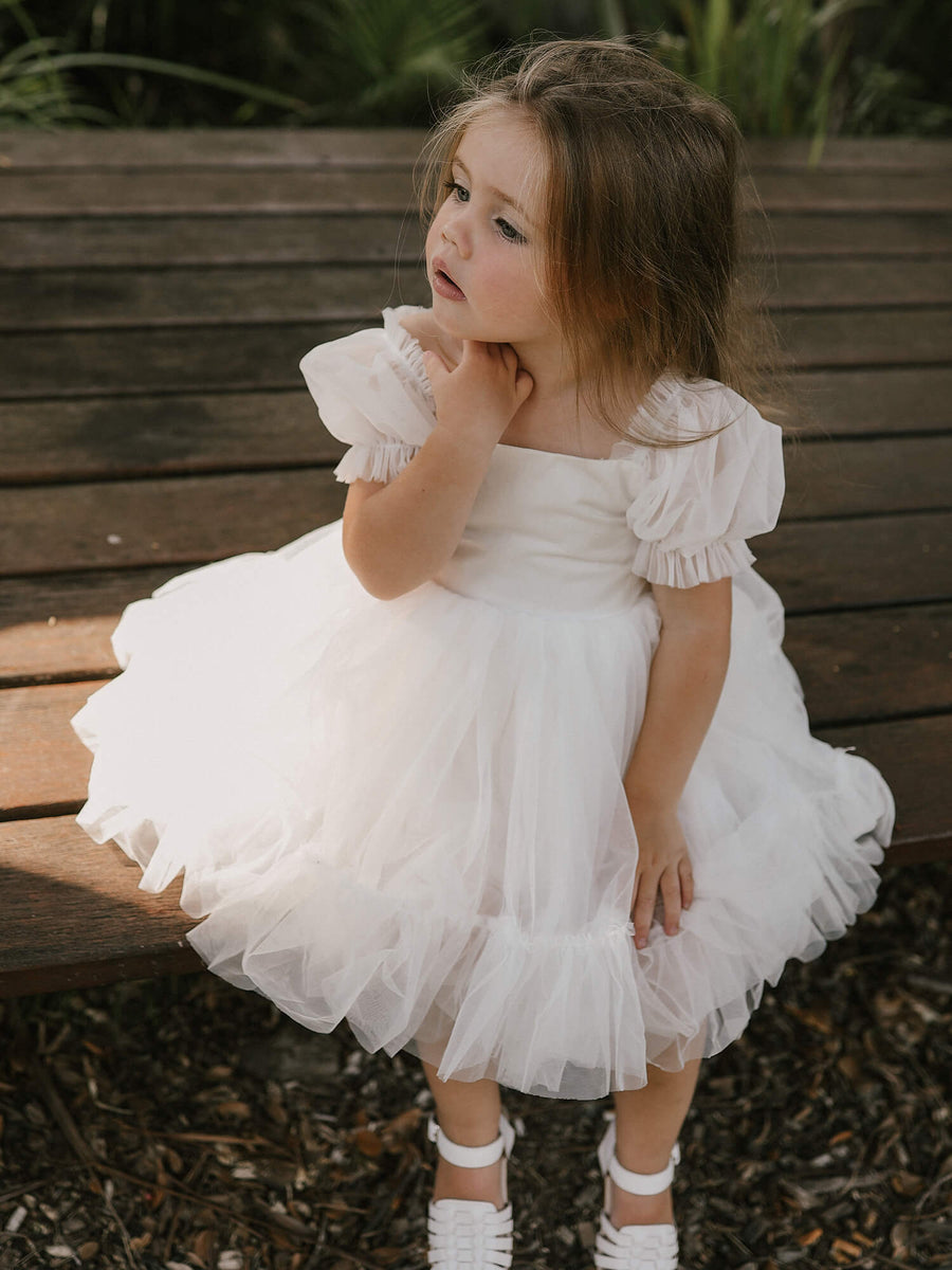 Cute kid girl 3-4 year old wearing stylish white dress and floral