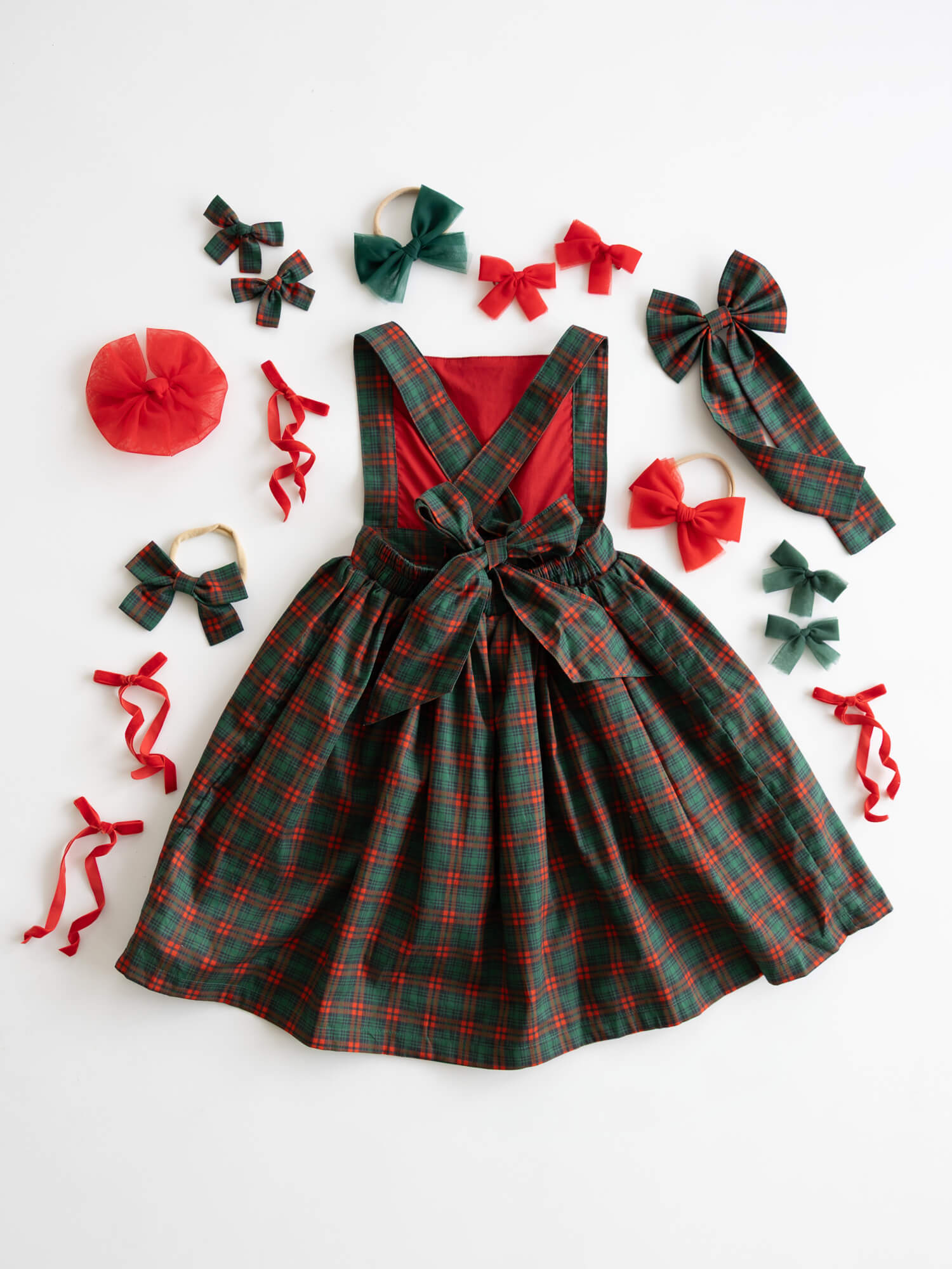 Green and red plaid dress with matching accessories on a white background.