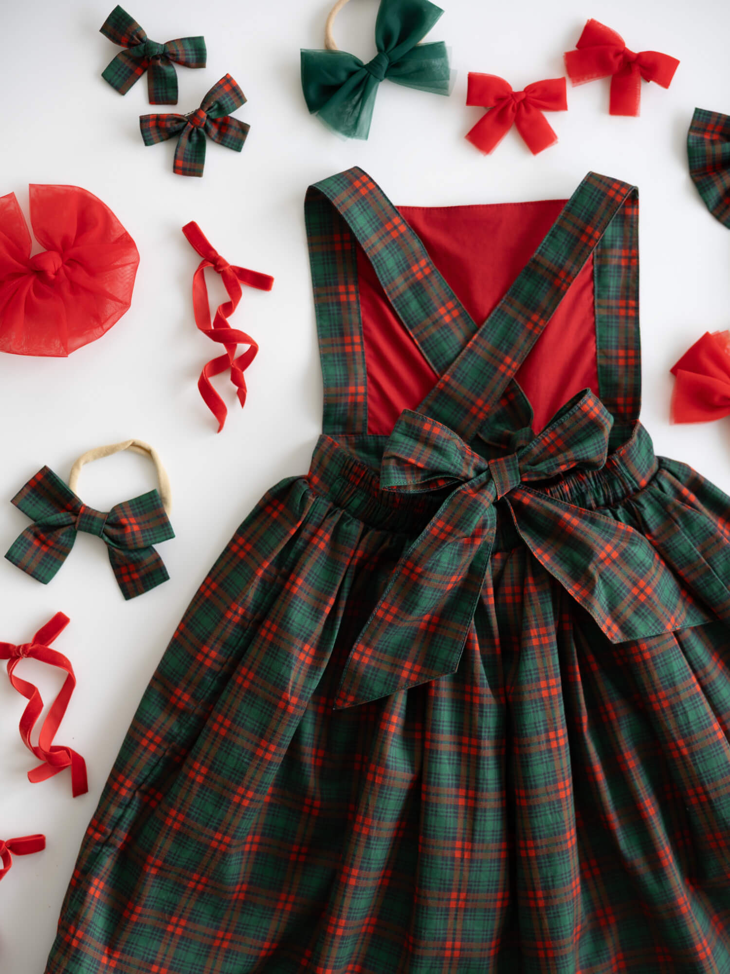 The back of our Ellie tartan Christmas dress, showing the bow at the back of the dress, along with matching accessories.