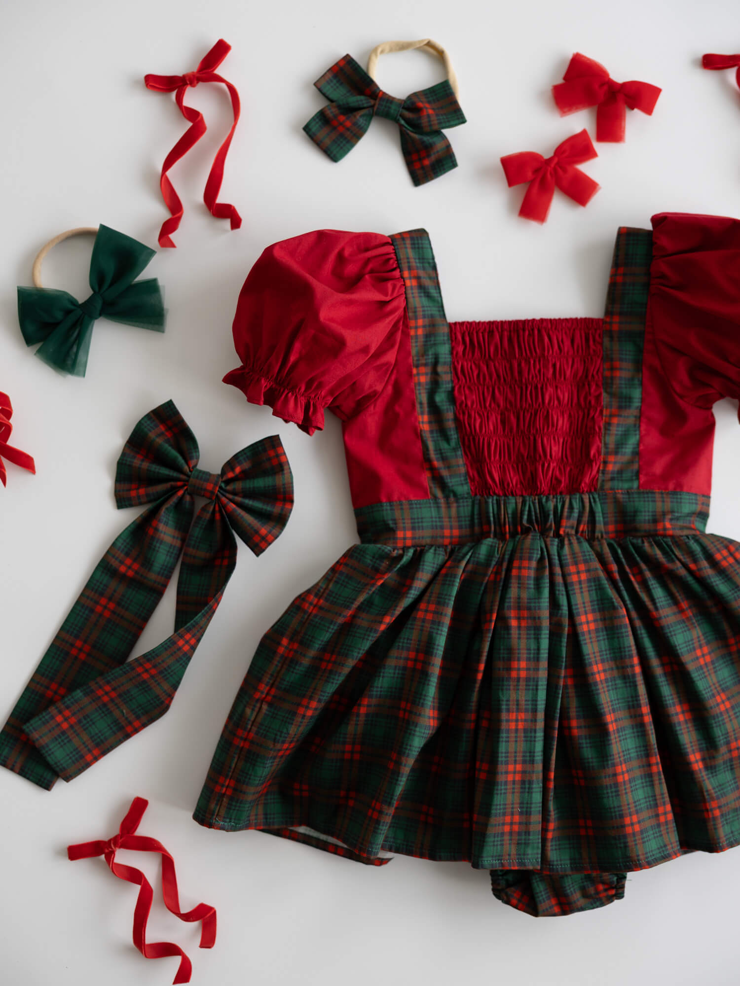 Red and green plaid Christmas romper with matching accessories on a white background.