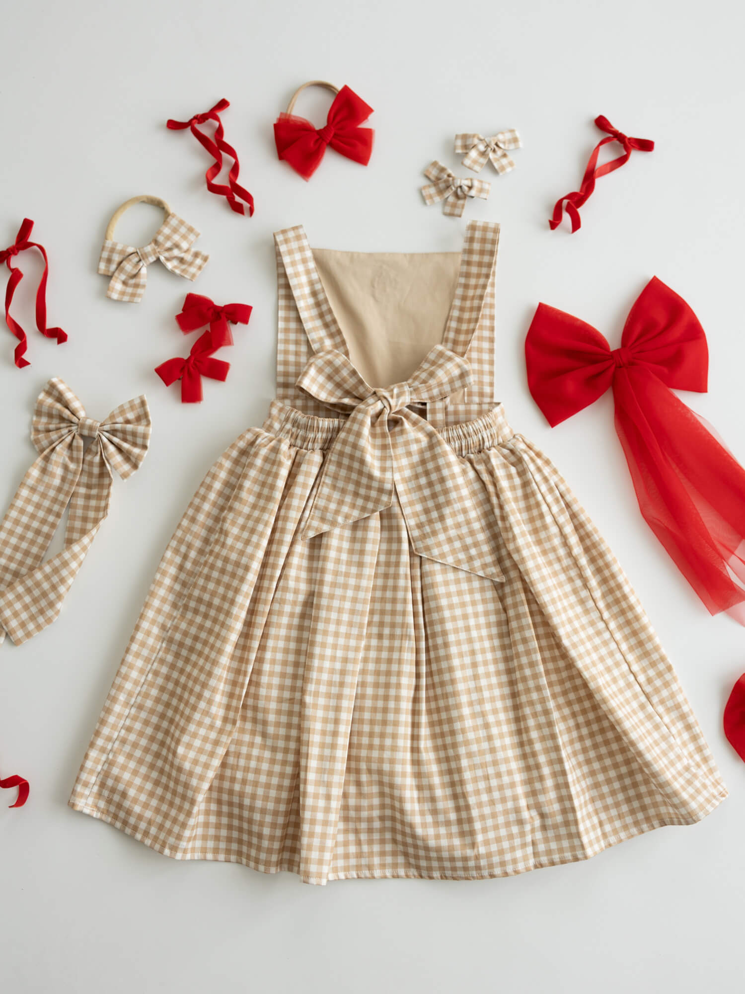 The back of our Ellie Gingerbread plaid Christmas dress, showing the bow at the back.