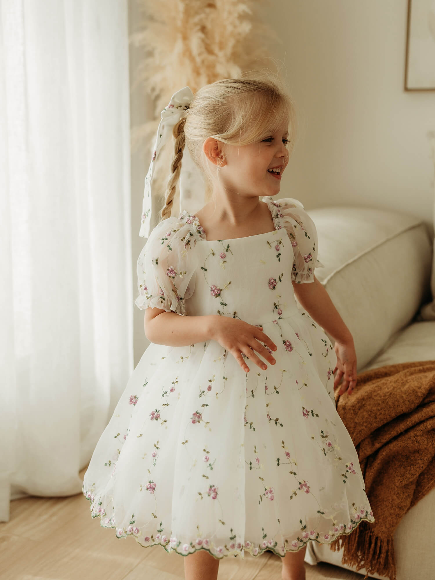 Fleur lilac girls party dress is worn by a young girl. She also wears the matching Fleur lilac hair bow for girls.