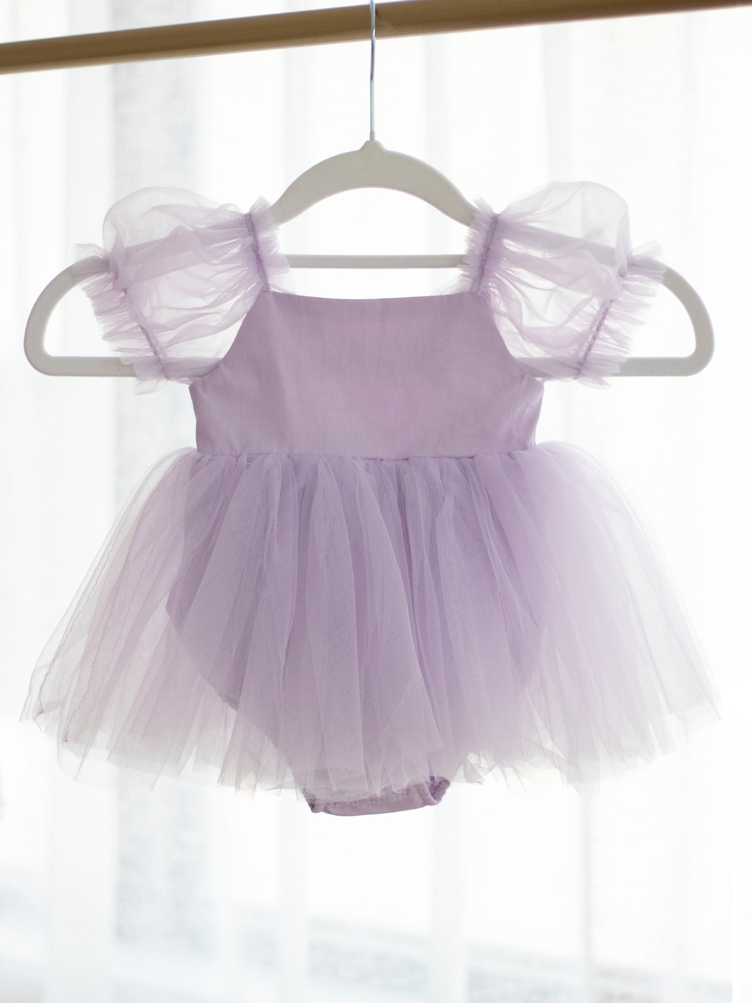 Gabrielle lilac tulle baby flower girl romper dress from the front.