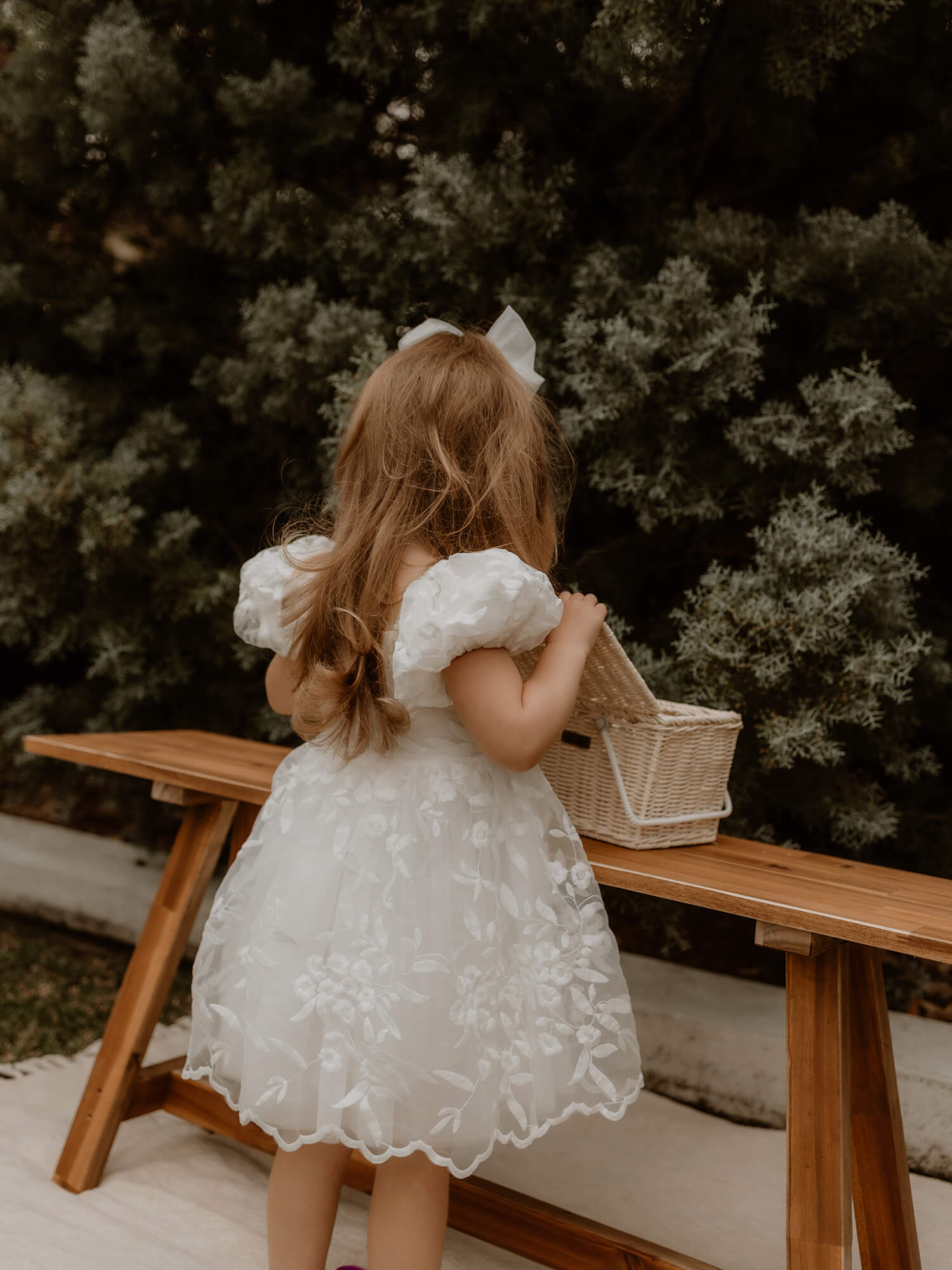 Kenzi puff sleeve flower girl dress showing the back, lace skirt and puff sleeves.