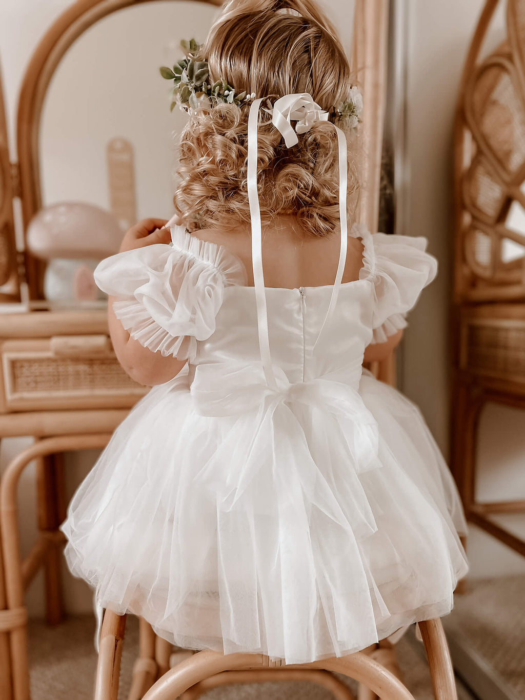 Toddler wears our Layla baby flower girl romper dress in ivory.