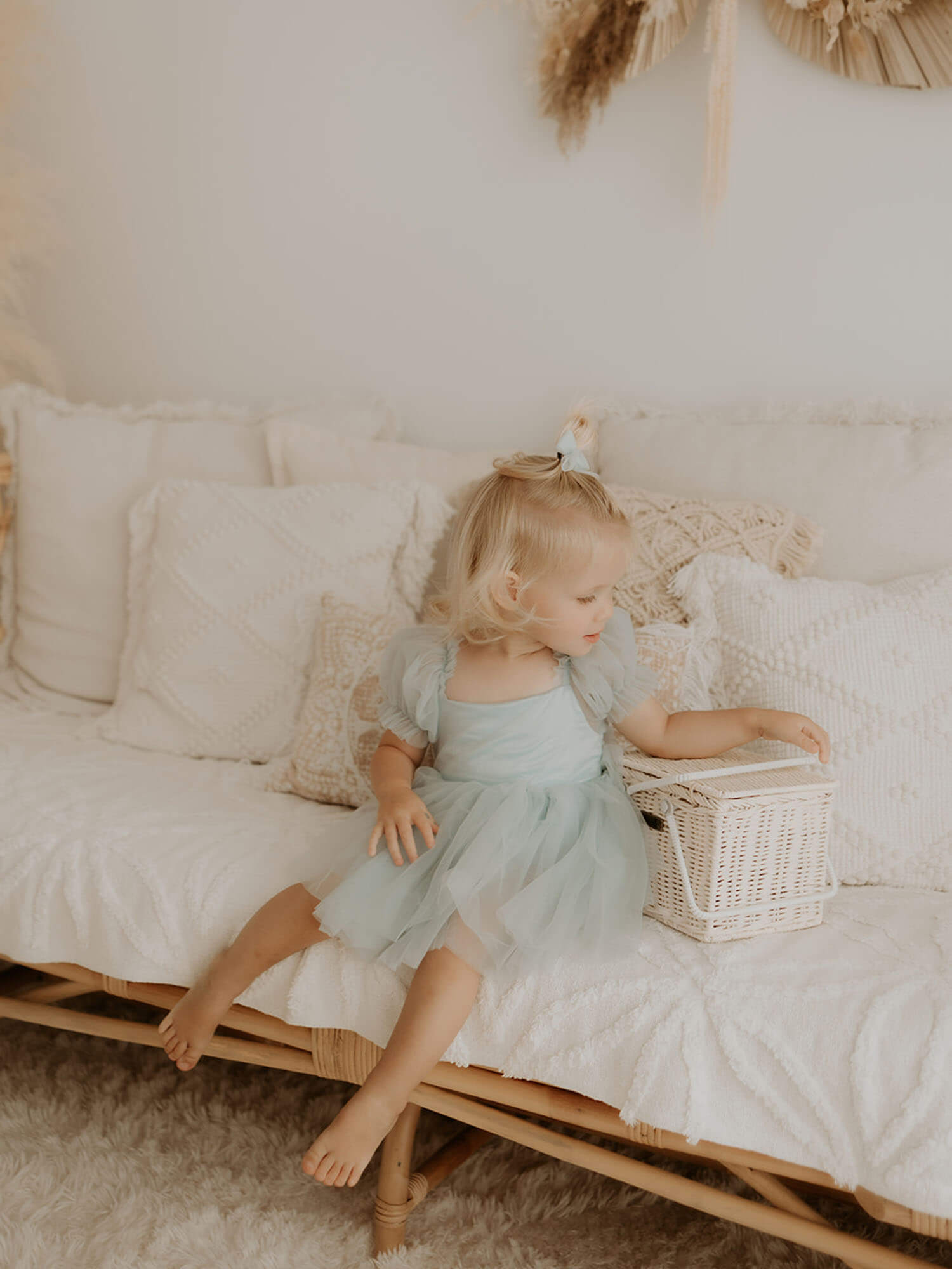 Layla baby girl flower girl romper in dusty blue is worn by a toddler.