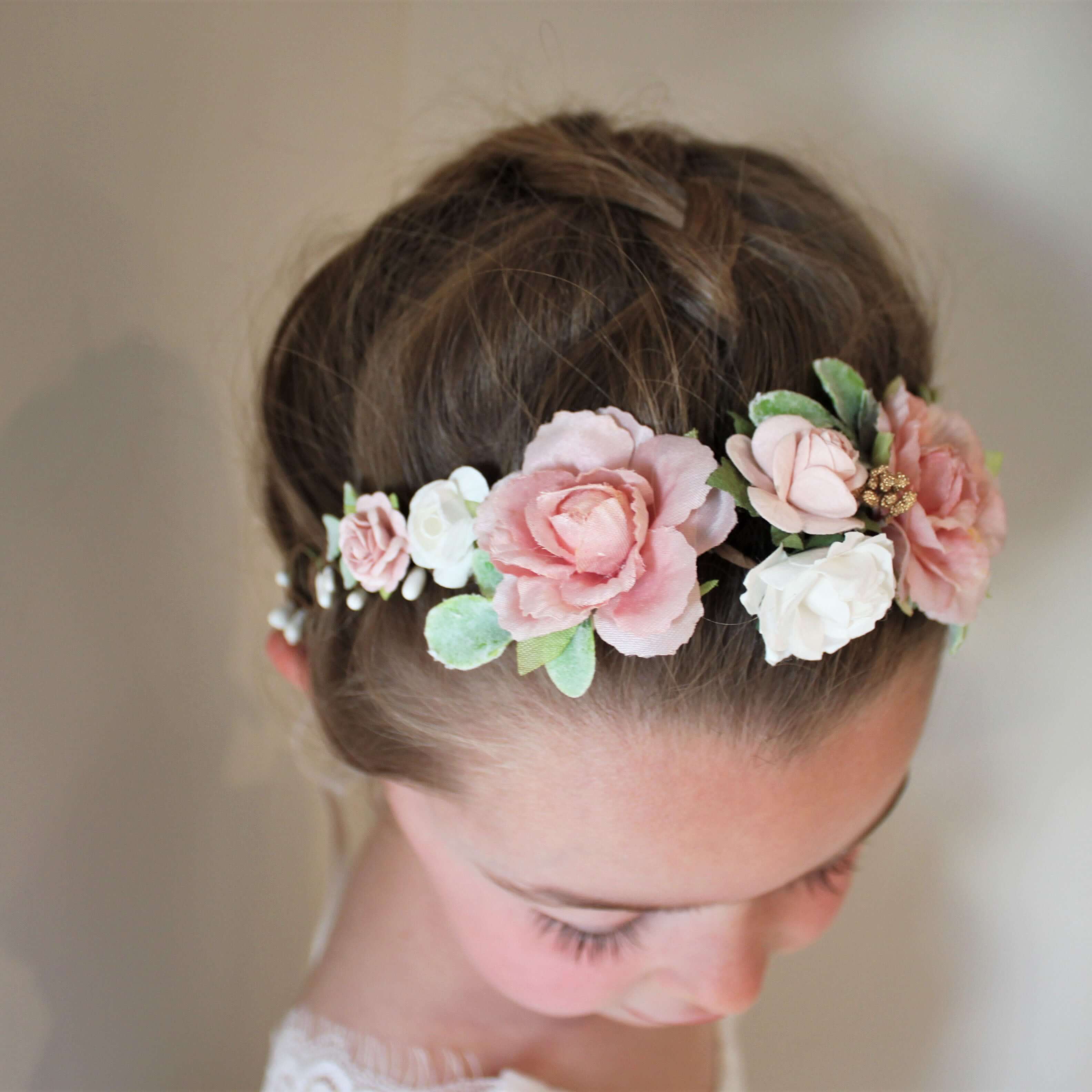 Child wears our Amelie flower crown which is dusty pink and ivory with gold accents.