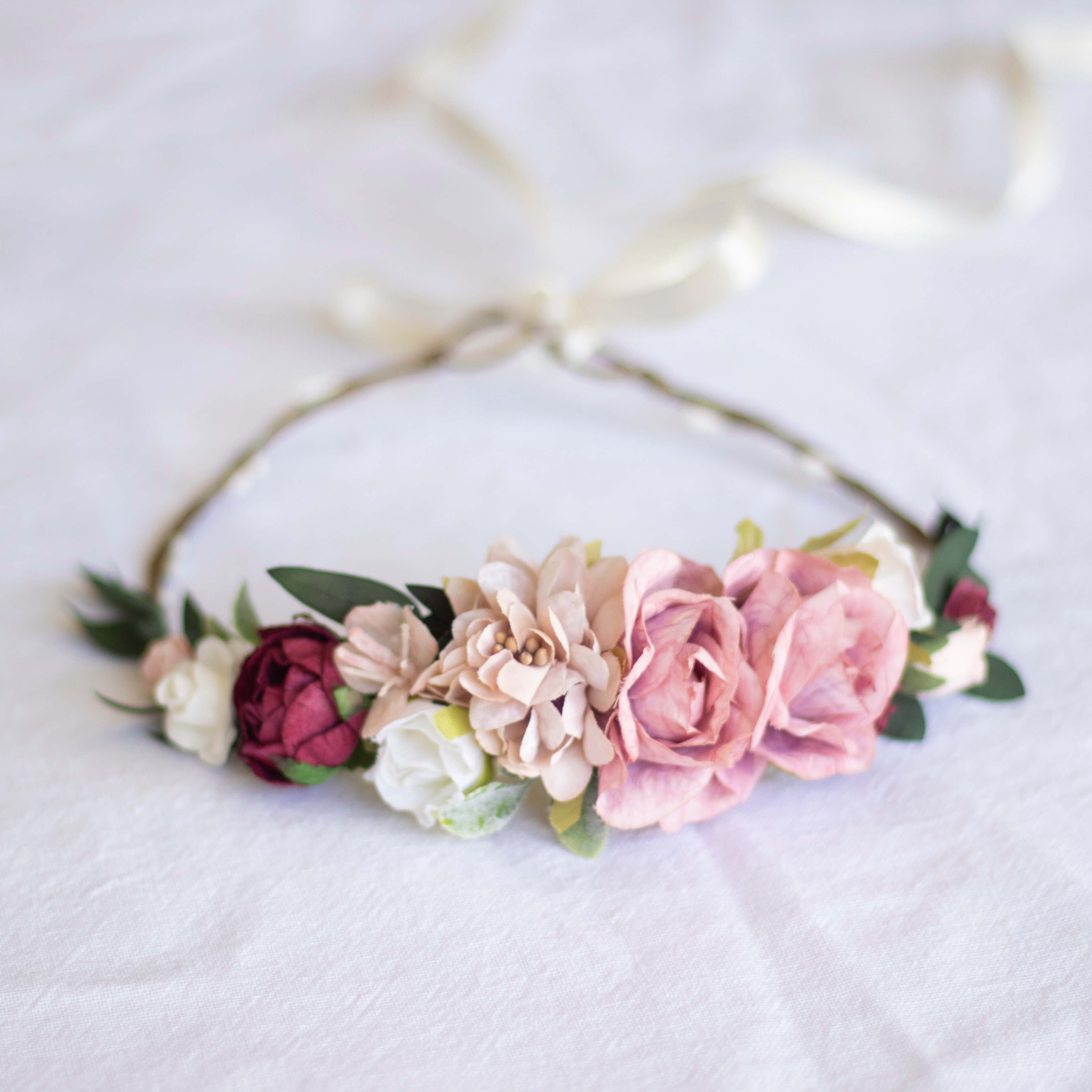 Audrey flower crown from the front, made up of taupe, pink, ivory and wine coloured blooms.