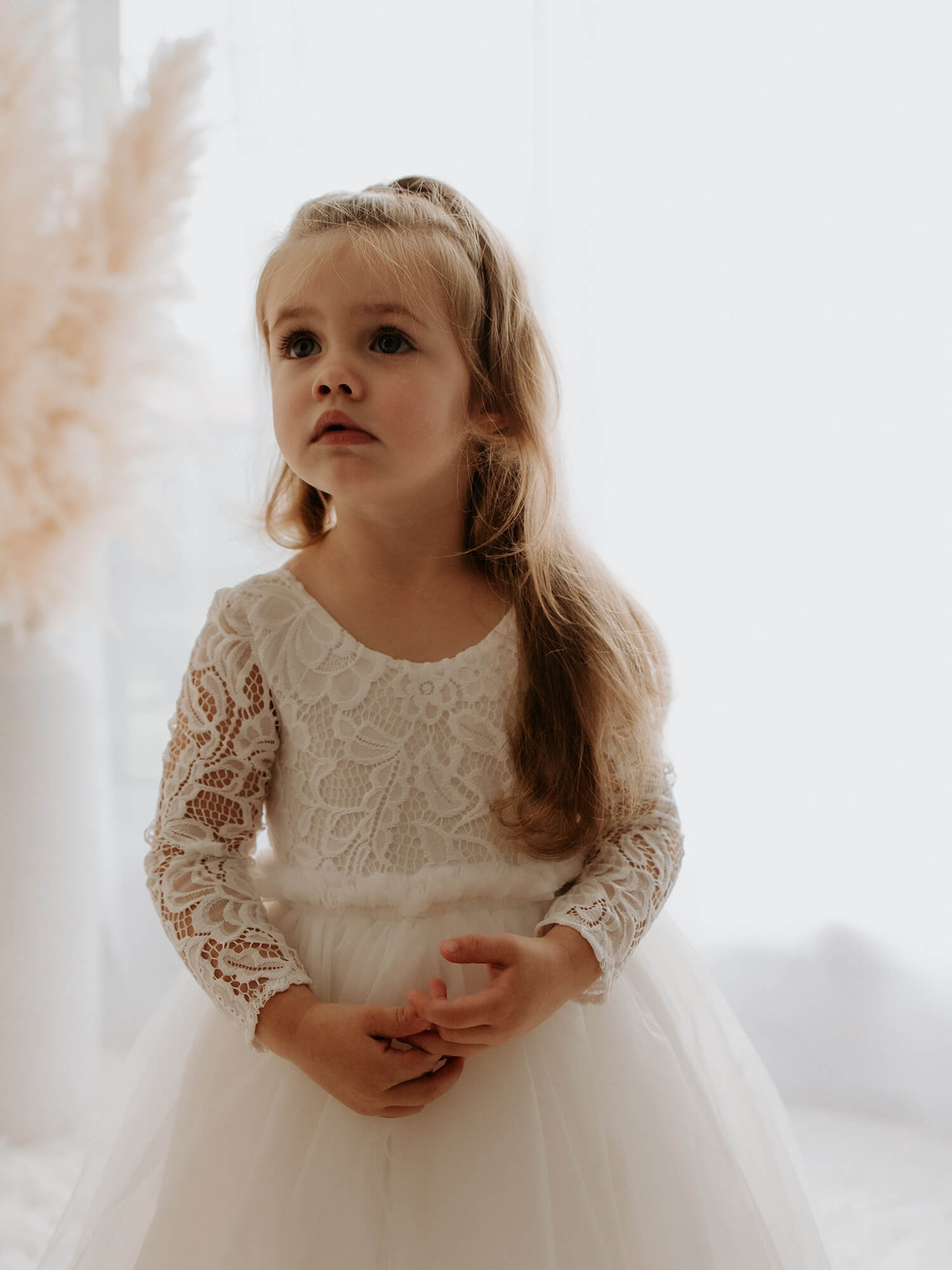 Belle flower girl dress lace bodice details, worn by a young flower girl.