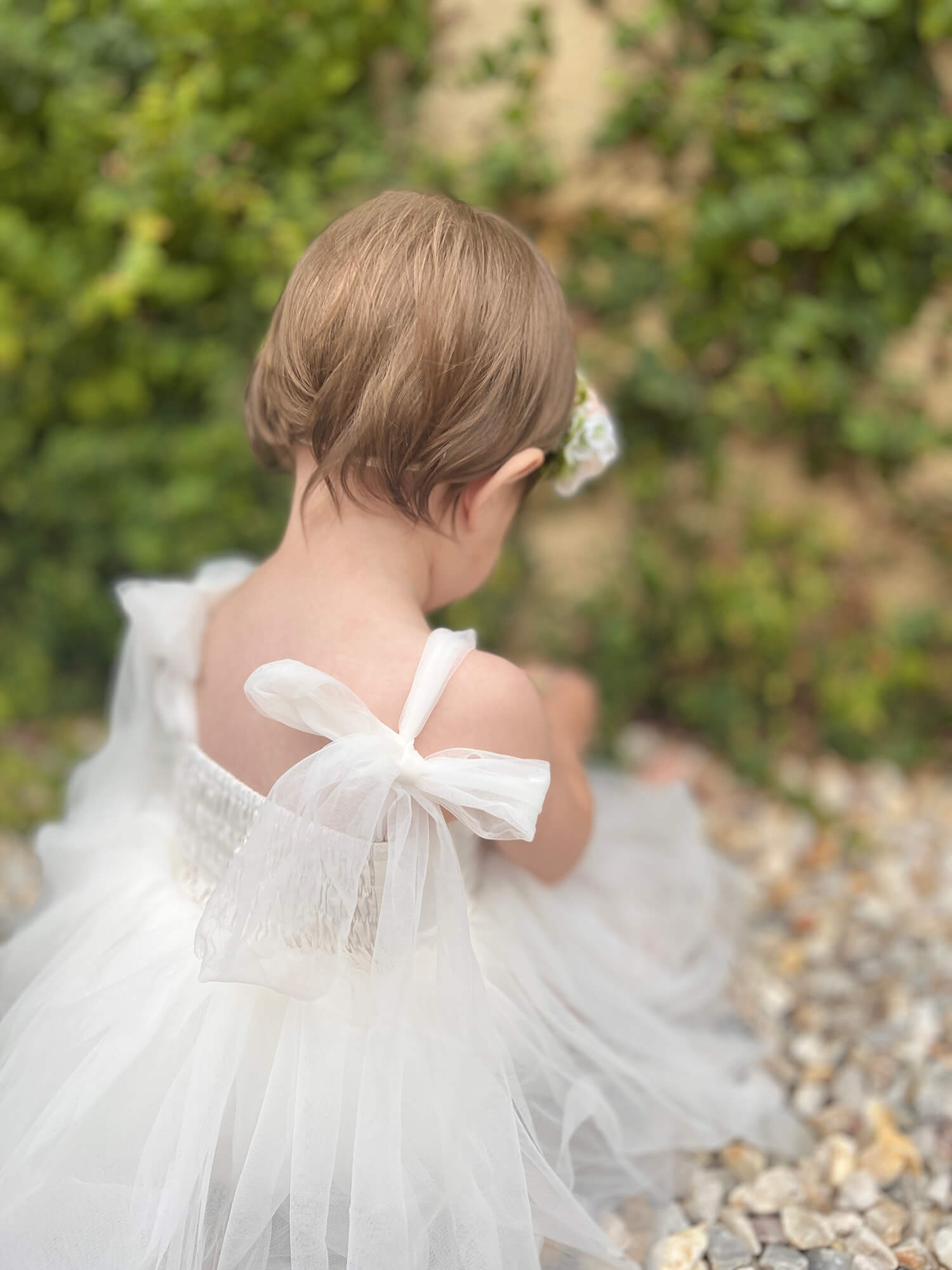 Harper baby flower girl romper showing the shirring at the back.