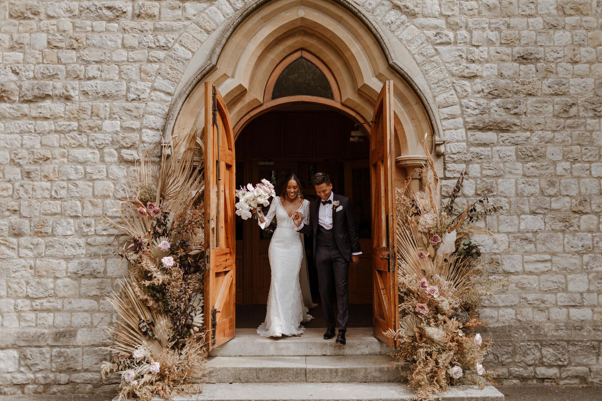 Bride Charlotte and Groom Patrick exit the church after their wedding ceremony.