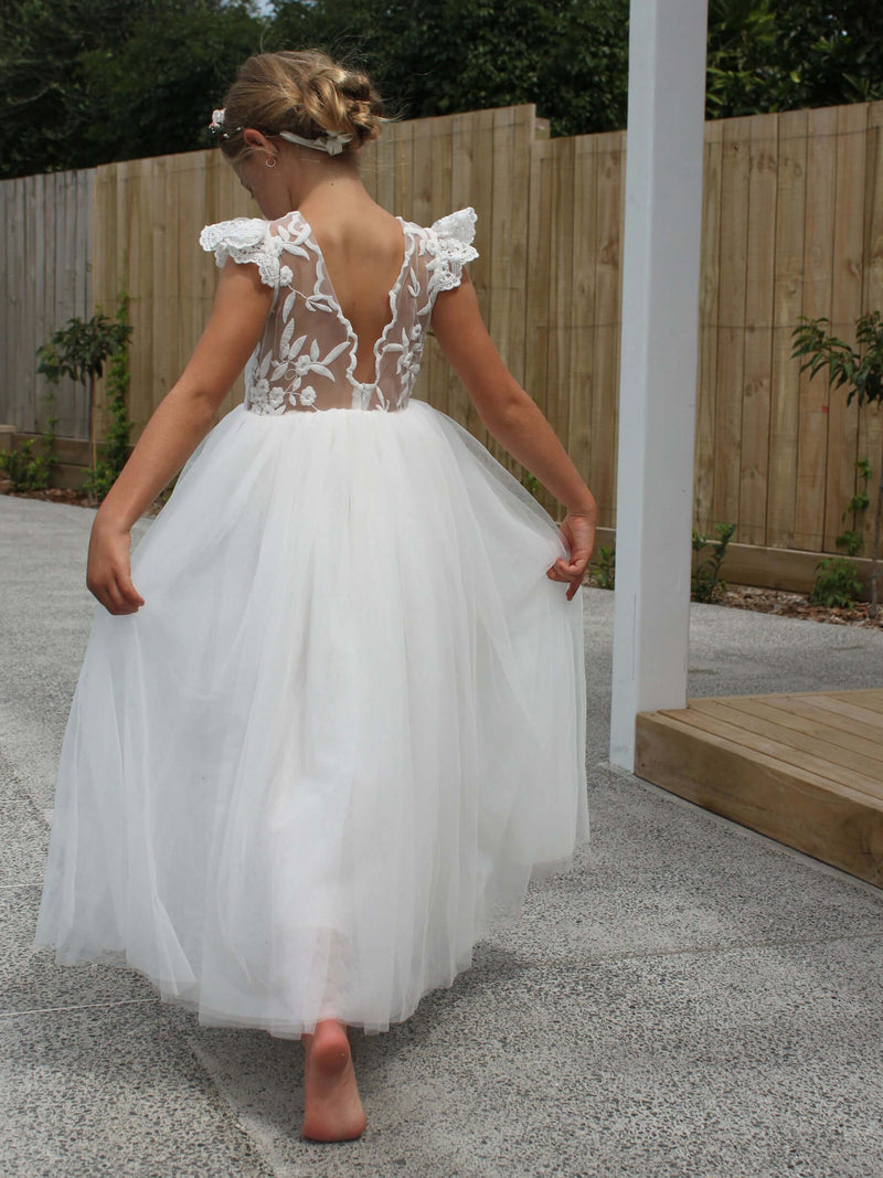 Abigail tulle flower girl dress worn by a young girl.