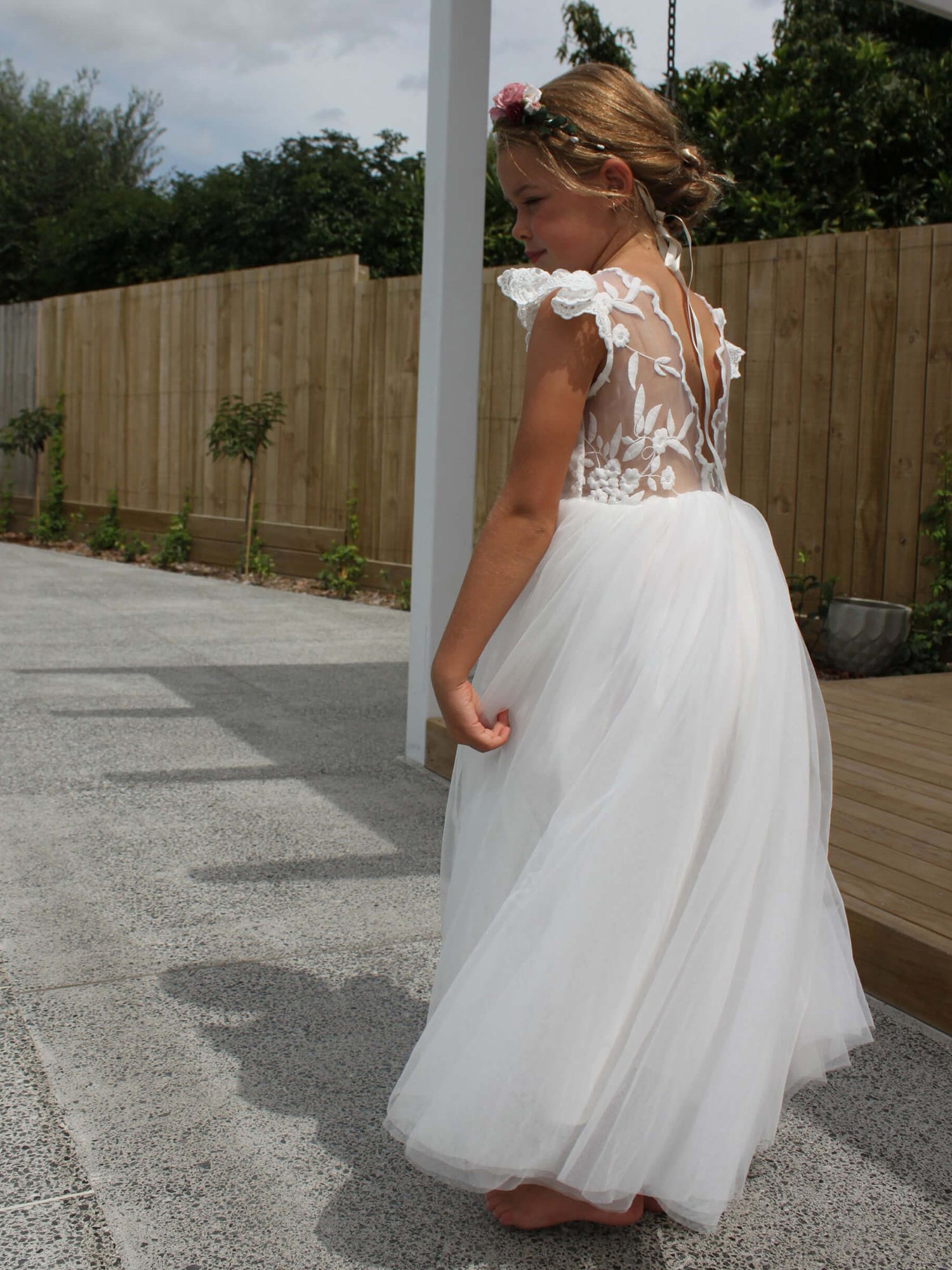 Full length white ivory flower girl dress, Abigail dress, worn by a young girl.