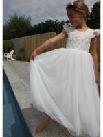 Abigail flower girl dress in ivory worn by a young girl, along with a flower crown.