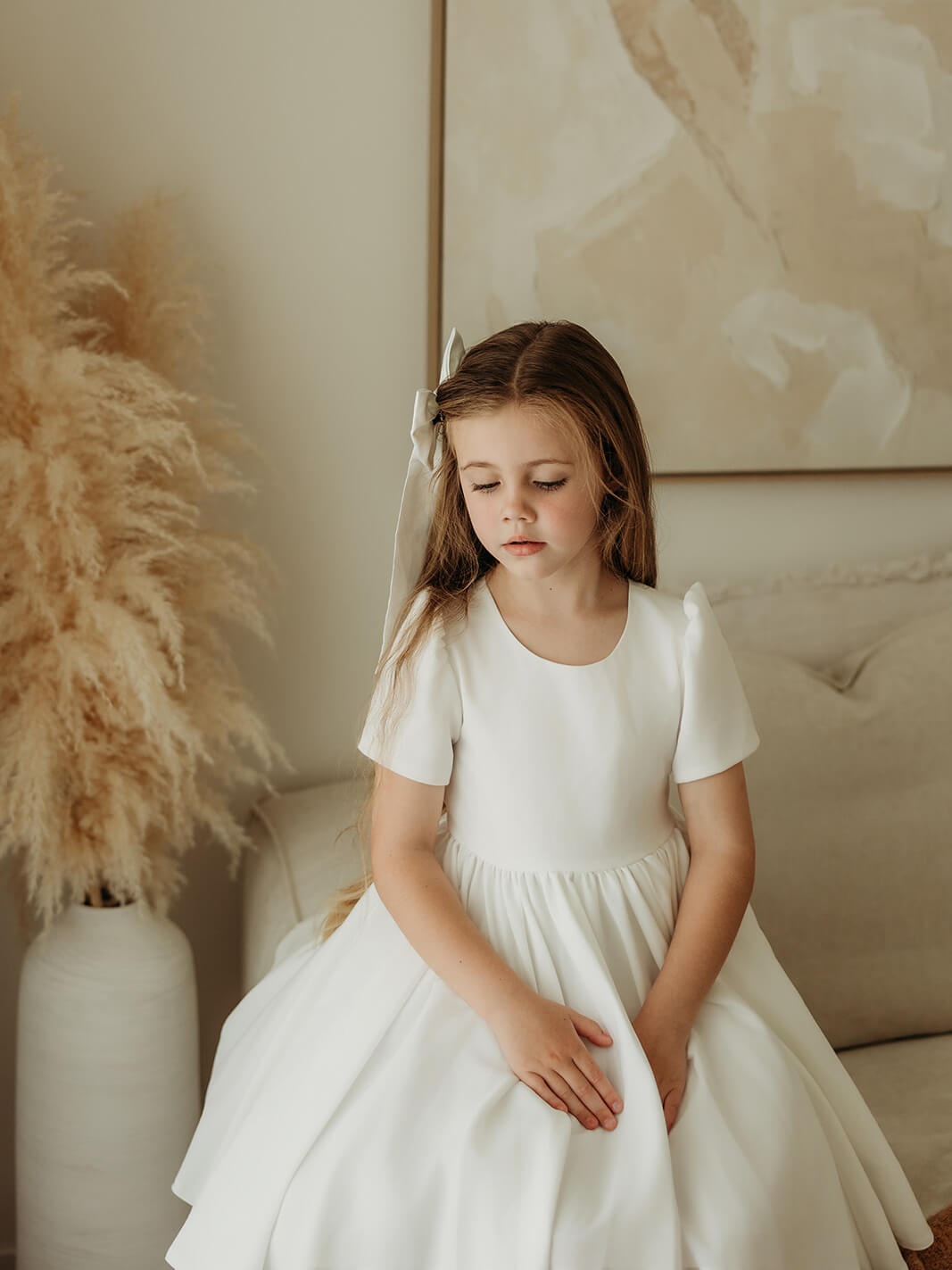 Our crepe Charlotte flower girl dress is worn by a young girl.