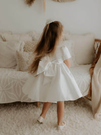 The back of our Charlotte flower girl dress, showing the large satin bow.