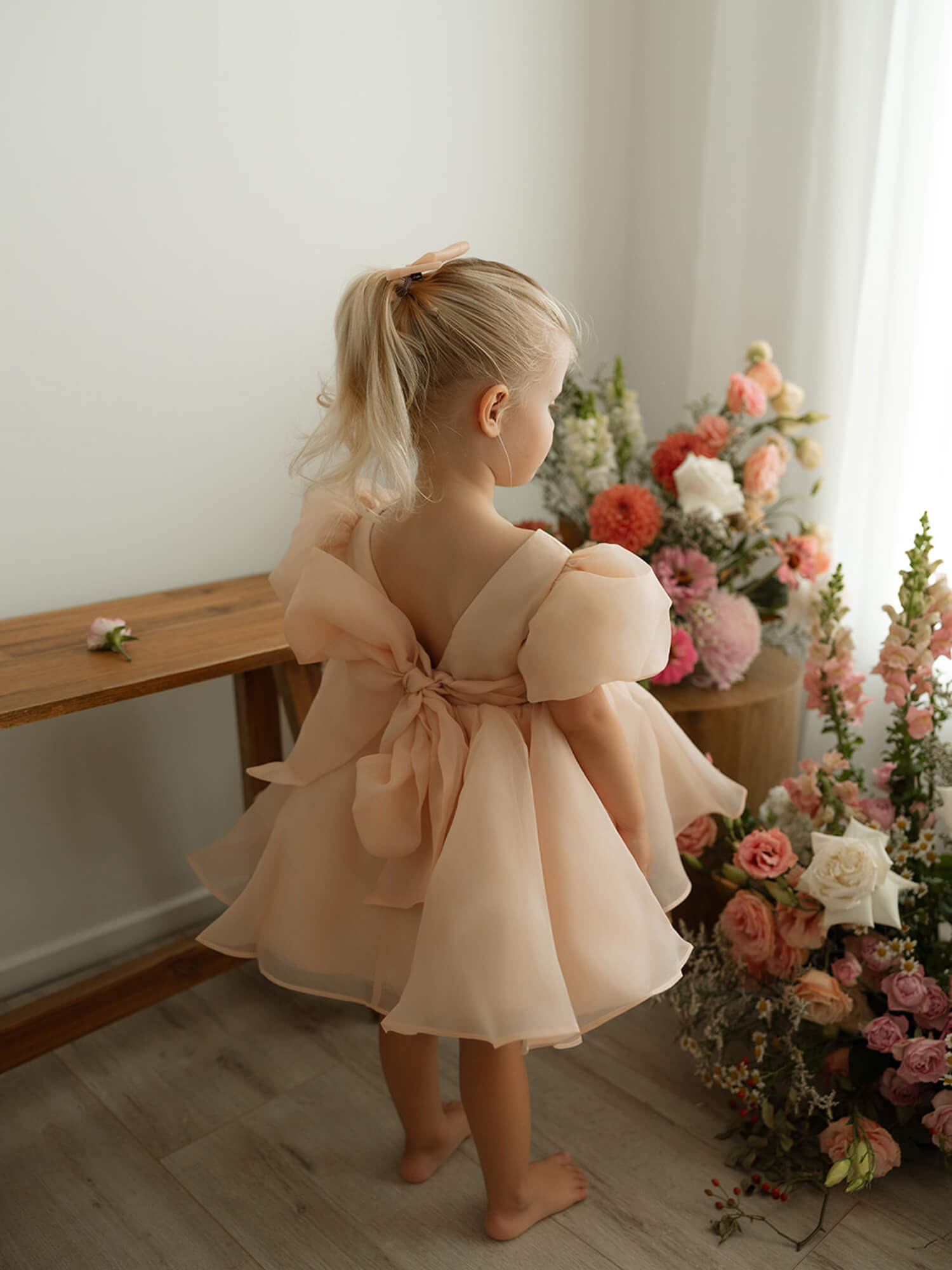 The back of our Cleo champagne puff sleeve flower girl dress.