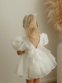 The organza back bow of the Cleo ivory puff sleeve baby flower girl dress.