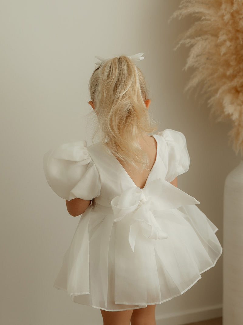 The organza back bow of the Cleo ivory puff sleeve baby flower girl dress.