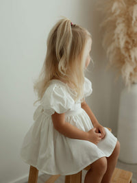 Cleo linen toddler flower girl dress with puff sleeves.