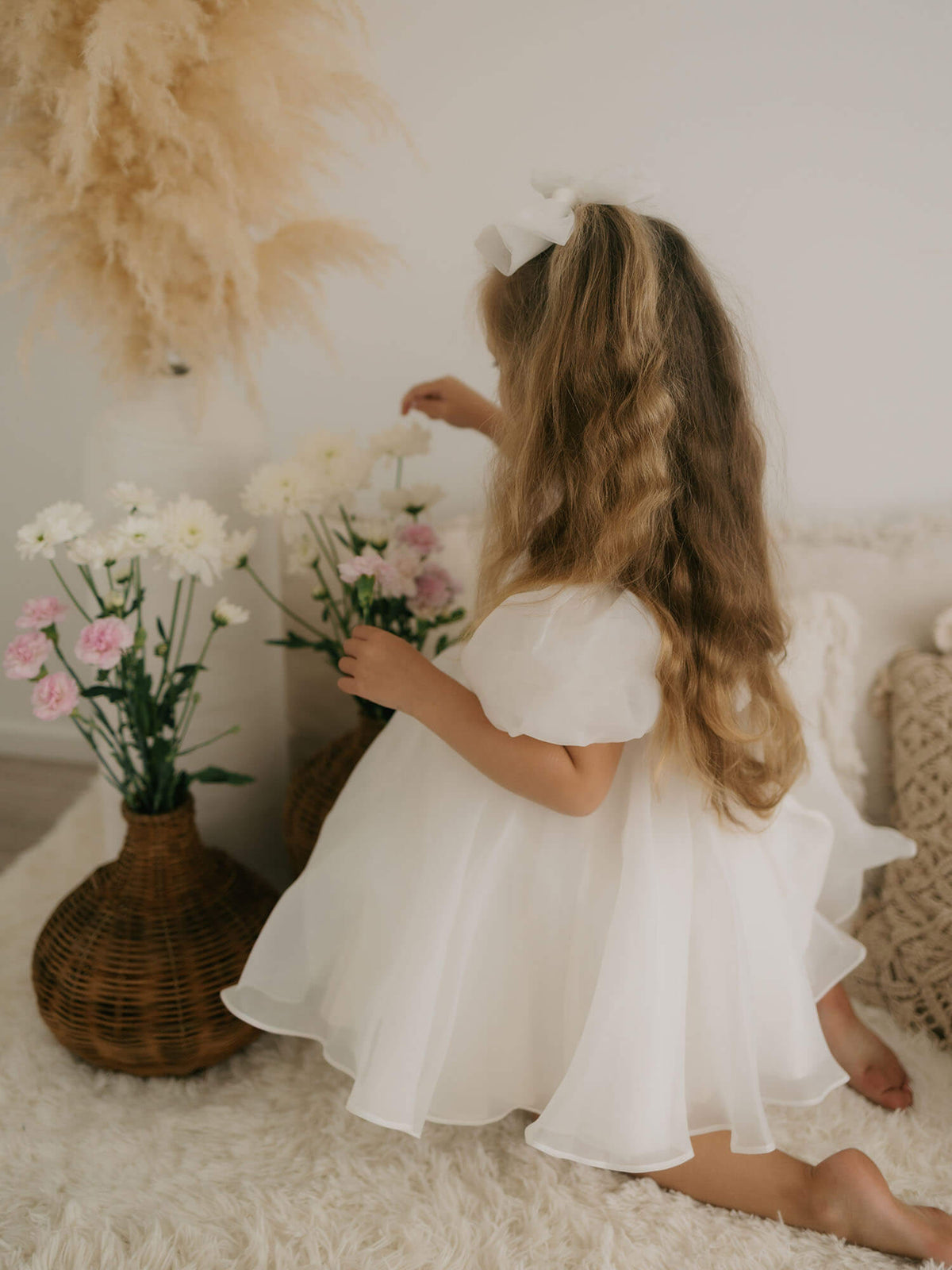 Cleo flower girl dress, showing the organza puff sleeves and puff skirt with built in petticoat.