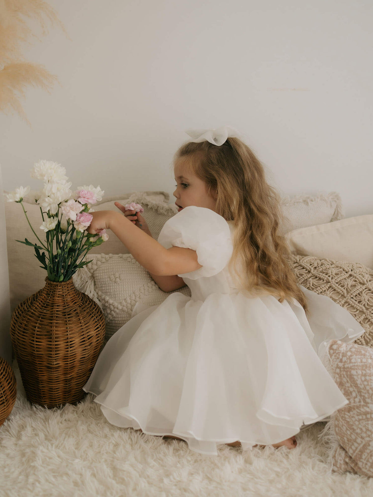 Cleo puff sleeve flower girl dress in light ivory, shown from the side featuring the beautiful organza puff sleeves.