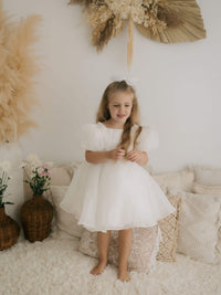 Cleo organza flower girl dress is worn by a young flower girl.