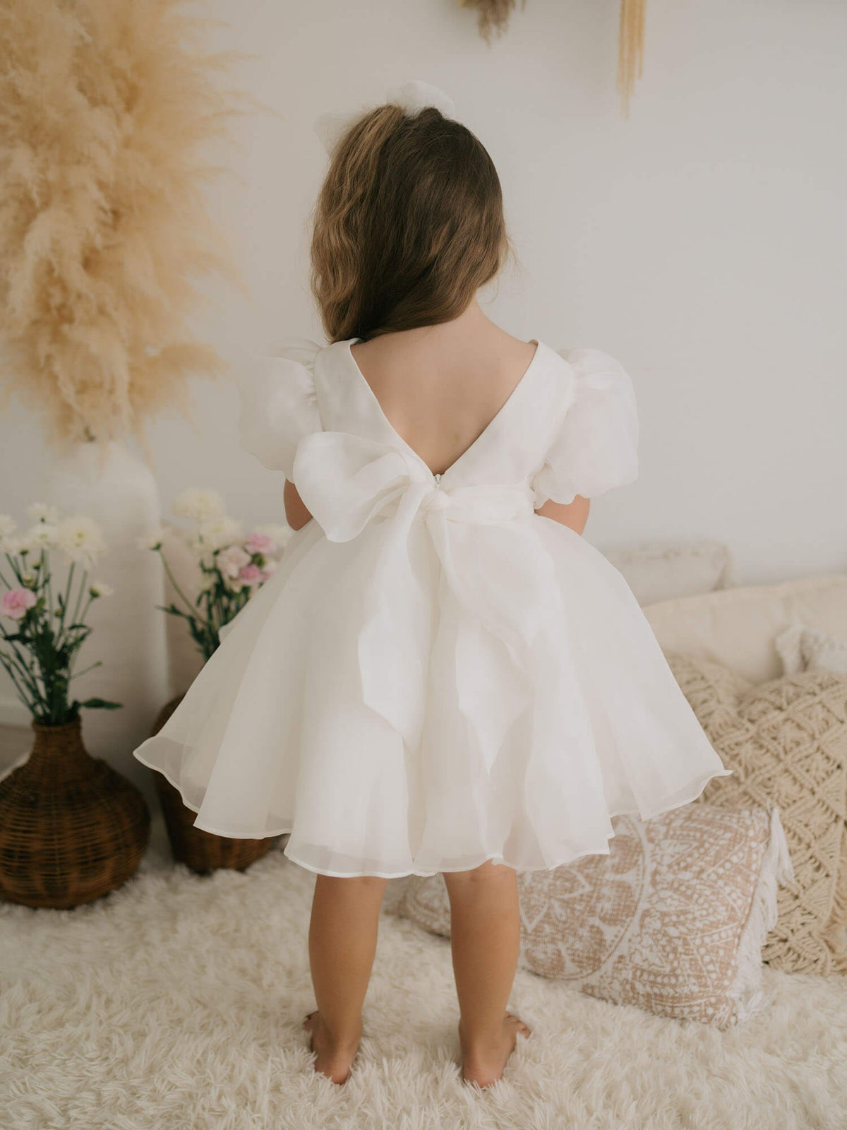 The back of our new Cleo puff sleeve flower girl dress with organza bow at the back.