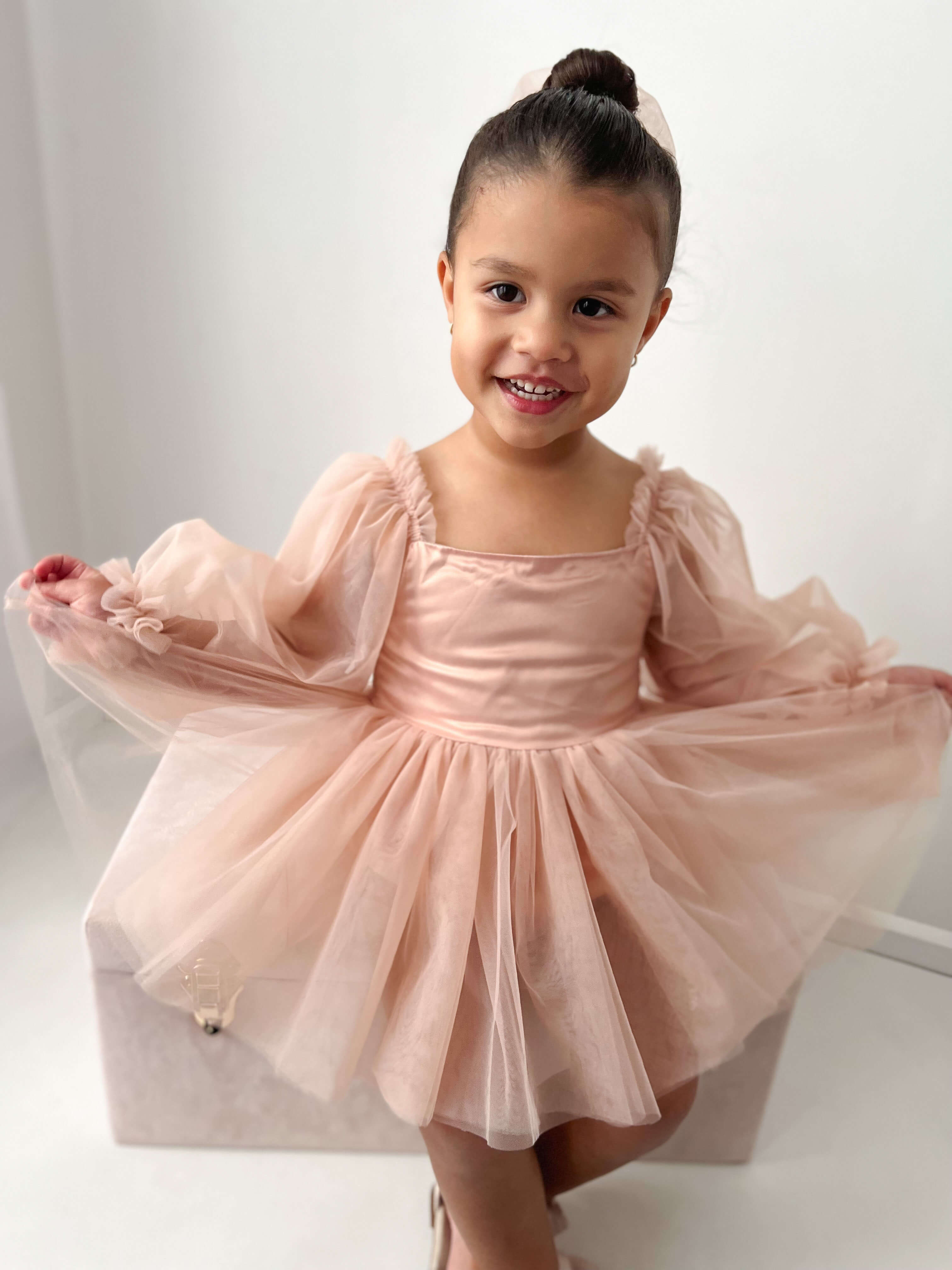 Eva champagne baby flower girl dress is worn by a young girl.