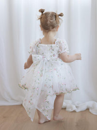 The back of our Fleur floral organza flower girl romper, with large organza back bow.