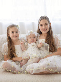 Three sisters wear our Fleur lemon blossom flower girl outfits.