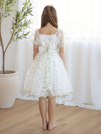 The back of our lemon yellow floral embroidered girls dress, the Fleur dress in lemon blossom.