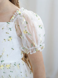 Details of the puff sleeve of our Fleur flower girl dress, showing the lemon floral embroidery.
