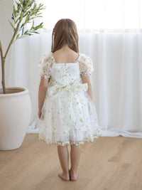 The back of our Fleur lemon blossom flower girl dress, showing the puff sleeves and organza bow at the back.