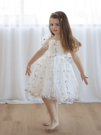 A little girl wears our Fleur floral embroidered organza flower girl dress.