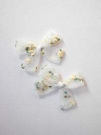 Fleur lemon blossom pigtail bows.