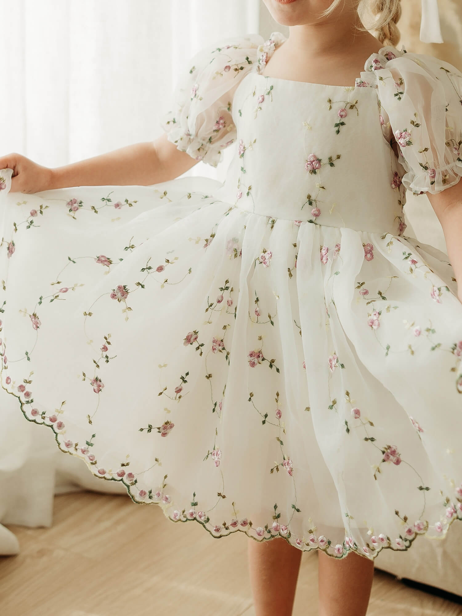 Fleur lilac floral flower girl dress is worn by a young girl.