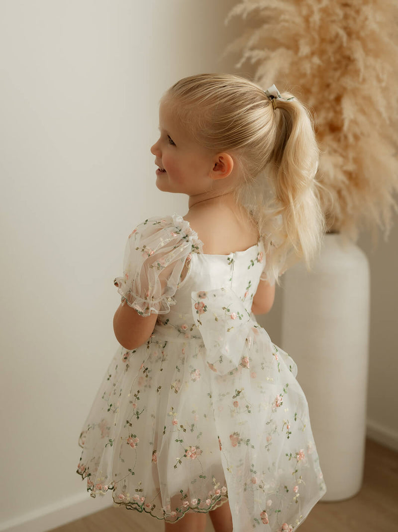 The back of our Fleur baby flower girl romper, showing the organza bow at the back.