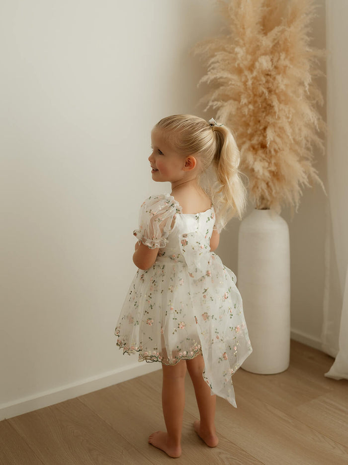 The back of our Fleur baby flower girl romper in meadow pink floral organza.