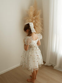 The back of our Fleur pink floral flower girl dress, showing the organza bow at the back.