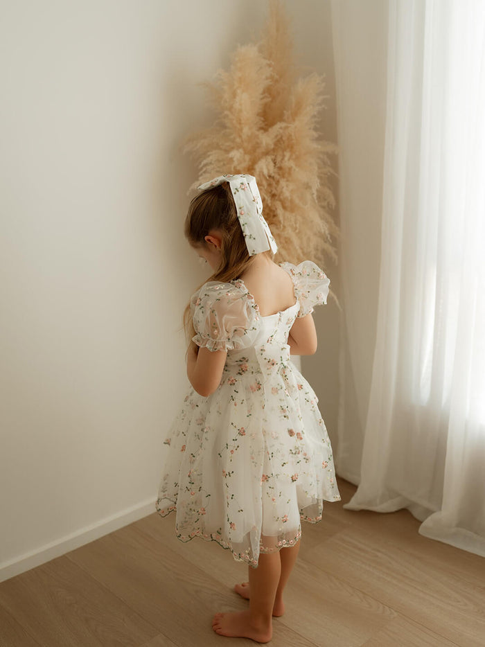 The back of our Fleur pink floral flower girl dress, showing the organza bow at the back.