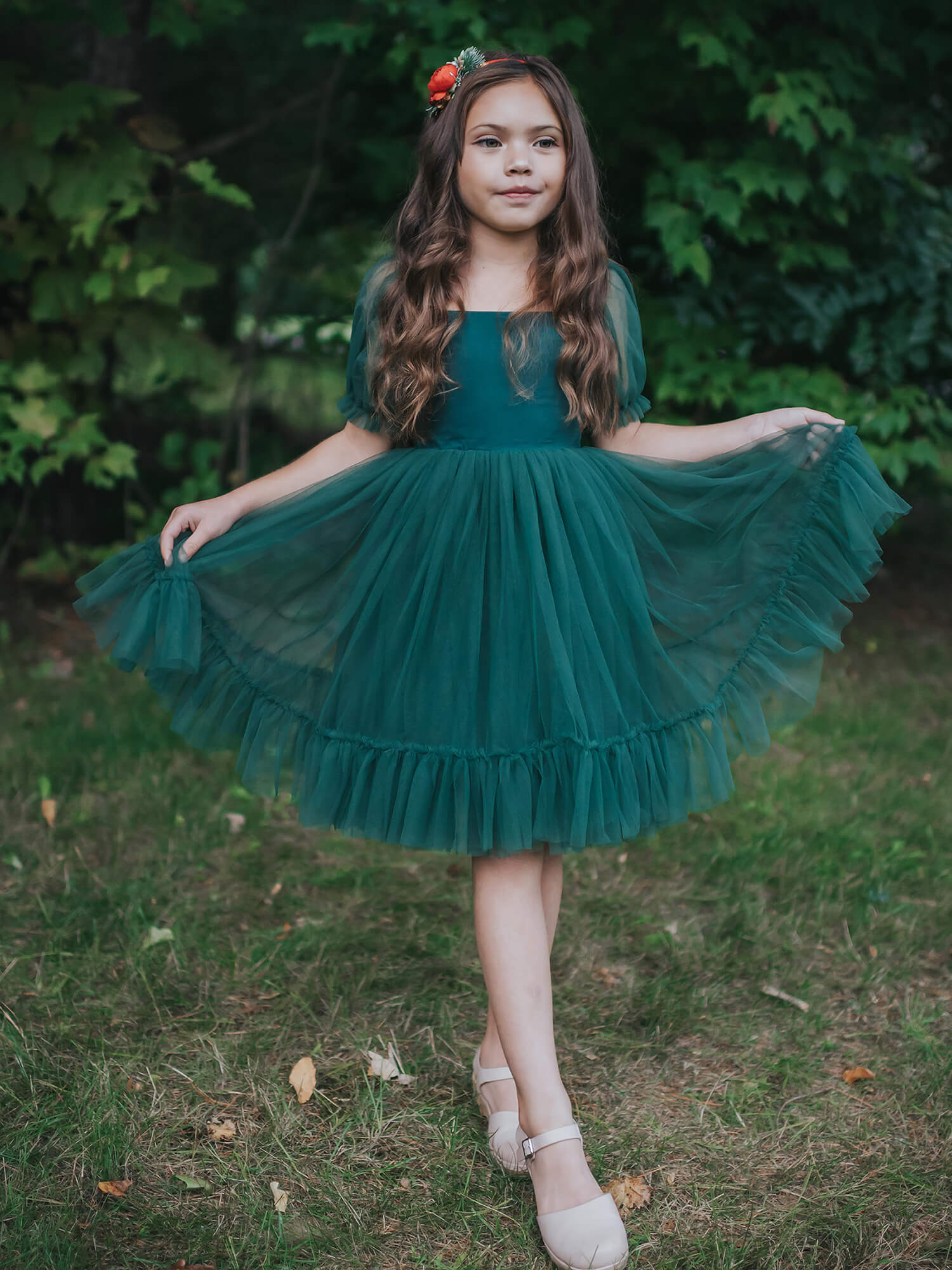 A young girl in our Gabrielle emerald Christmas dress with tulle skirt.