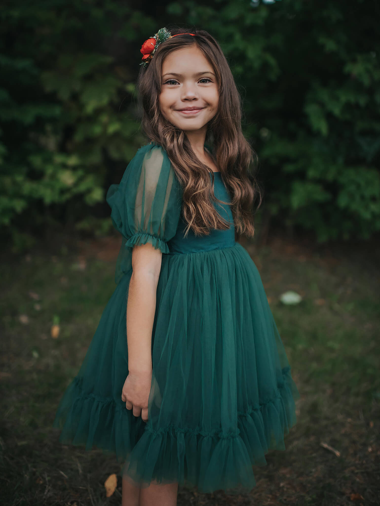 Gabrielle emerald tulle Christmas dress is worn by a young girl.