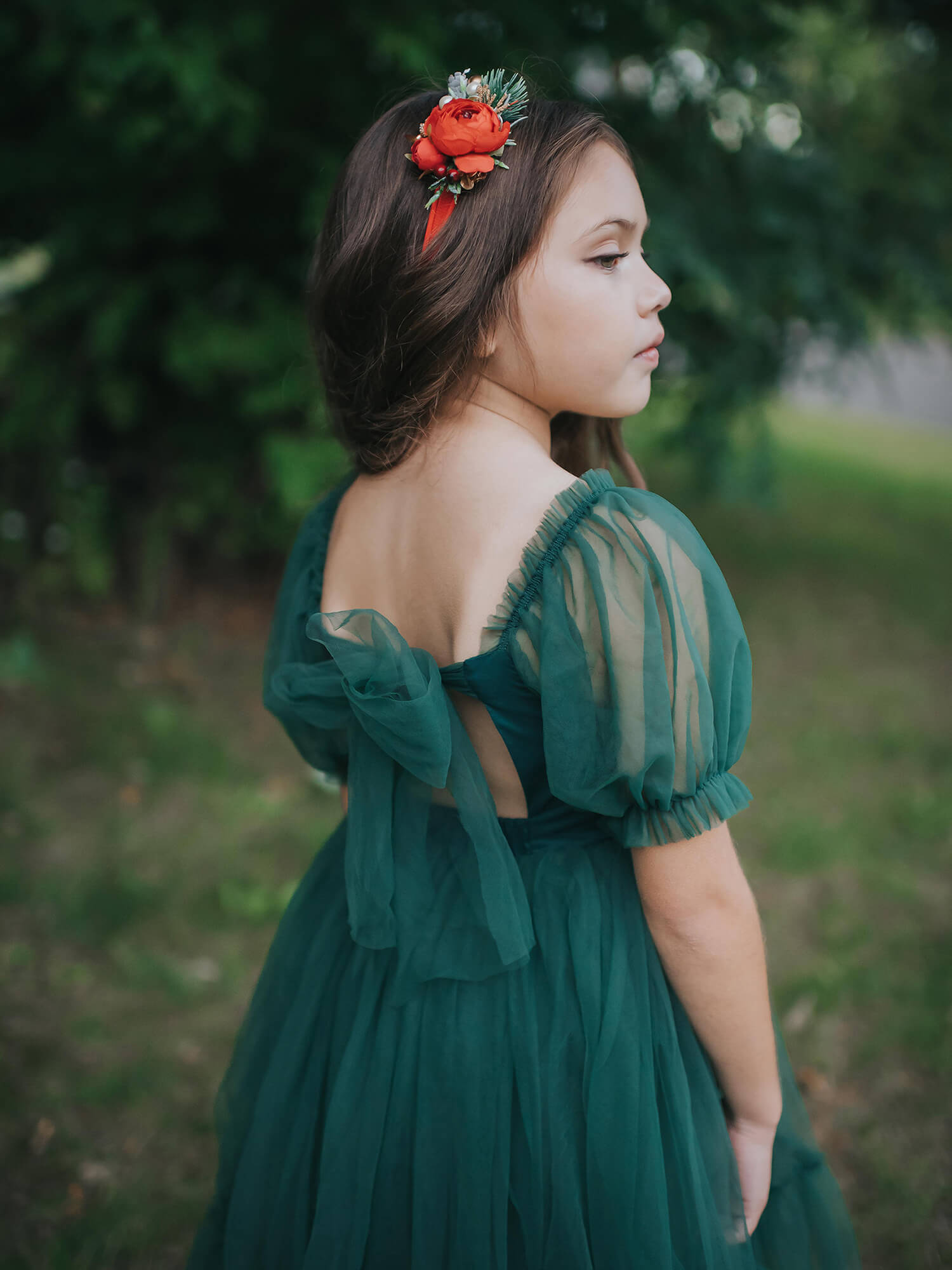 Gabrielle emerald green tulle dress showing the tulle bow at the back and tulle puff sleeves.
