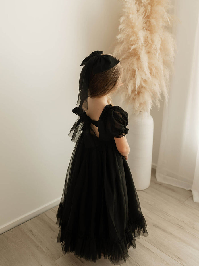 The back of our Gabrielle black full length dress showing the tulle bow detail at the back.