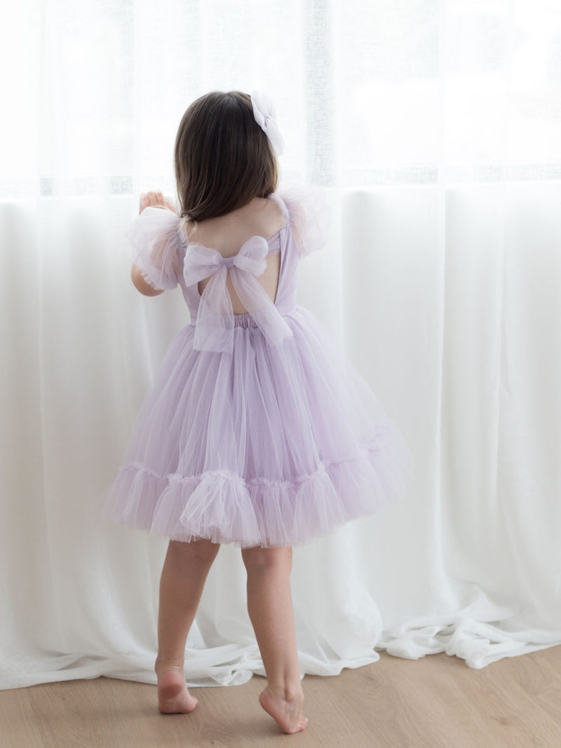 The back of the Gabrielle lilac flower girl dress showing the tulle bow at the back.