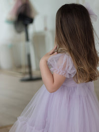 Tulle puff sleeves of the Gabrielle lilac flower girl dress.