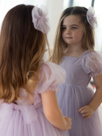 Gabrielle pastel purple flower girl dress is worn by a young girl.