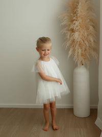 Gia baby flower girl dress is worn by a young girl.