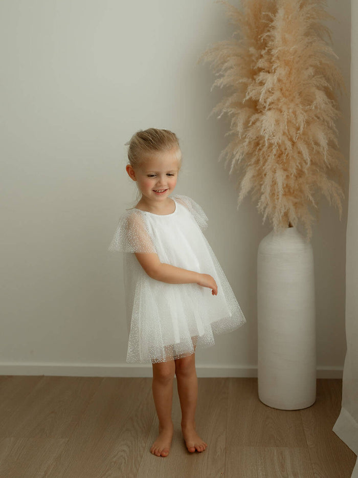 Gia baby flower girl dress is worn by a young girl.